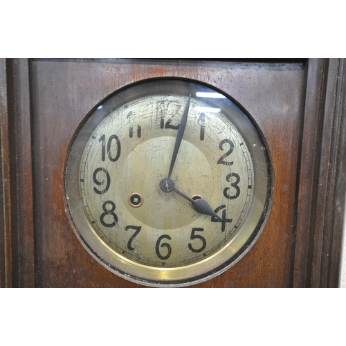 1331 - AN EARLY TO MID 20TH CENTURY OAK WALL CLOCK, with winding key and pendulum (condition - some losses)