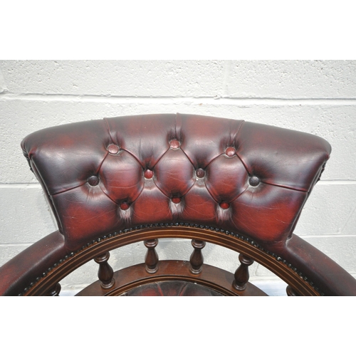 1340 - A BURGUNDY LEATHER BUTTONED SWIVEL OFFICE CHAIR, with spindled armrests, on five shaped legs, width ... 