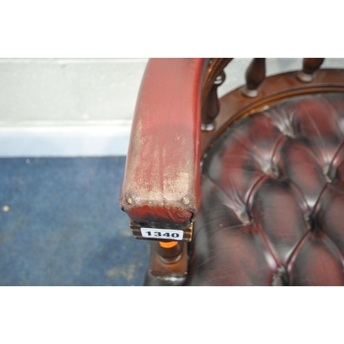 1340 - A BURGUNDY LEATHER BUTTONED SWIVEL OFFICE CHAIR, with spindled armrests, on five shaped legs, width ... 