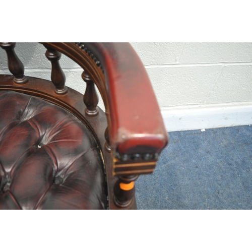 1340 - A BURGUNDY LEATHER BUTTONED SWIVEL OFFICE CHAIR, with spindled armrests, on five shaped legs, width ... 