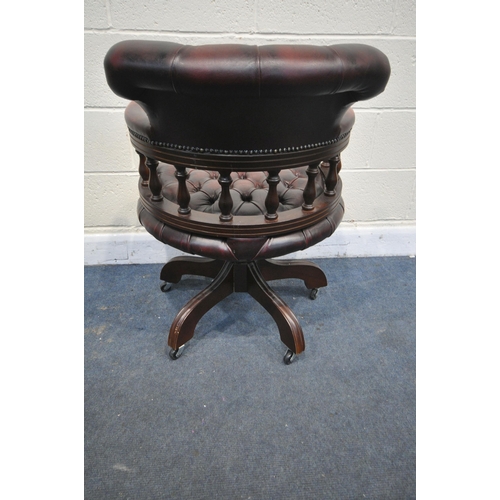 1340 - A BURGUNDY LEATHER BUTTONED SWIVEL OFFICE CHAIR, with spindled armrests, on five shaped legs, width ... 