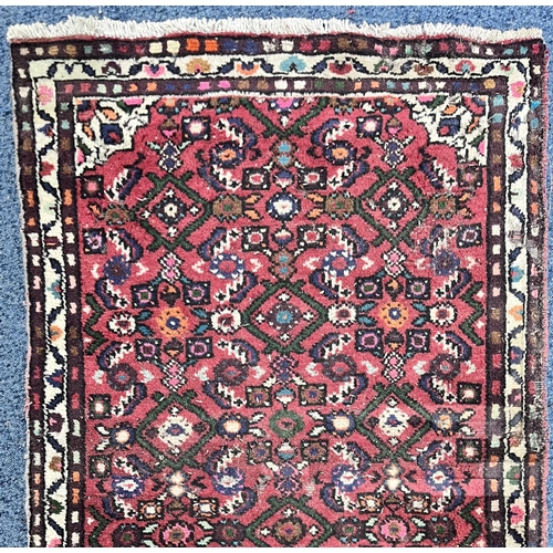 1363 - A 19TH CENTURY PERSIAN HOSSEINABAD CARPET RUNNER, red field, central cream medallion, length 284cm x... 