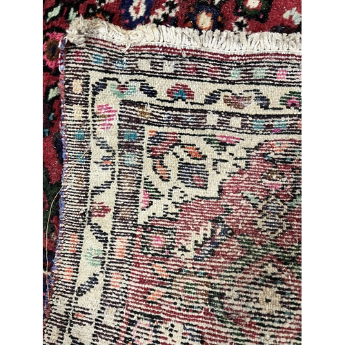 1363 - A 19TH CENTURY PERSIAN HOSSEINABAD CARPET RUNNER, red field, central cream medallion, length 284cm x... 