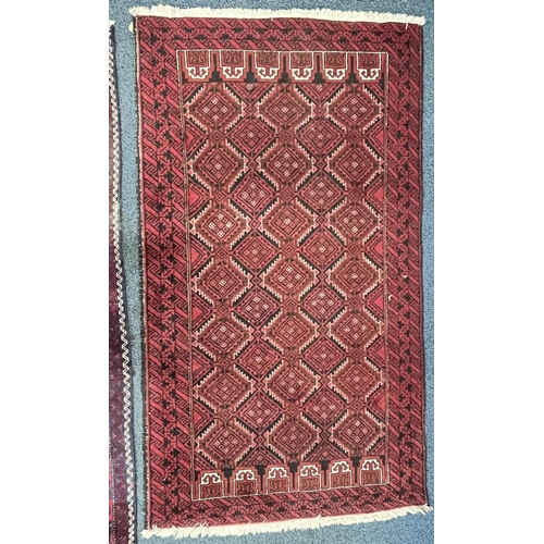 1366 - A 20TH CENTURY IRANIAN RED GEOMETRIC PATTERNED RUG, 193cm x 111cm, and a red tekke rug, 200cm x 96cm... 