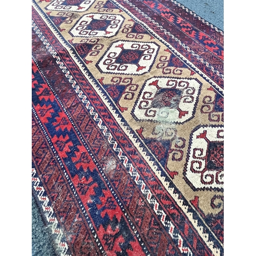 1366 - A 20TH CENTURY IRANIAN RED GEOMETRIC PATTERNED RUG, 193cm x 111cm, and a red tekke rug, 200cm x 96cm... 