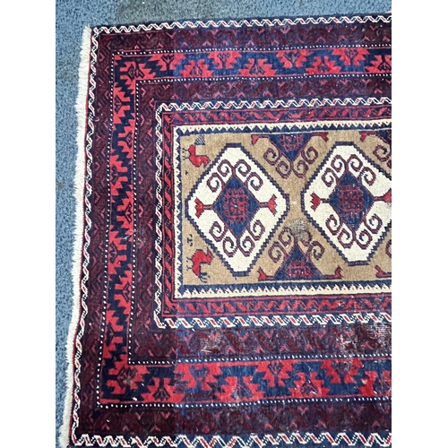 1366 - A 20TH CENTURY IRANIAN RED GEOMETRIC PATTERNED RUG, 193cm x 111cm, and a red tekke rug, 200cm x 96cm... 