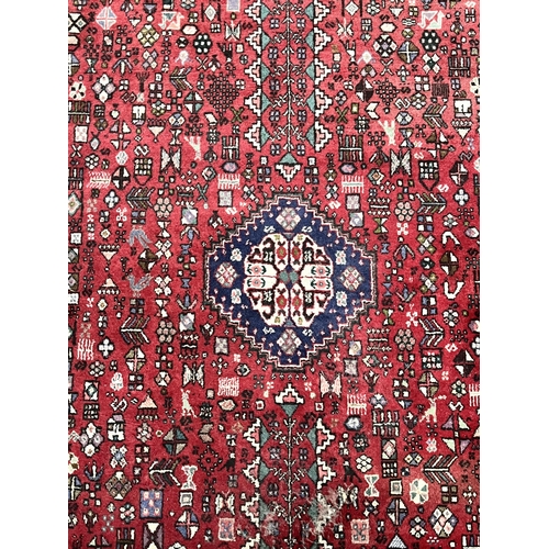 1368 - A 20TH CENTURY IRANIAN ABADEH RUG, typical design with a central medallion, with a central red field... 