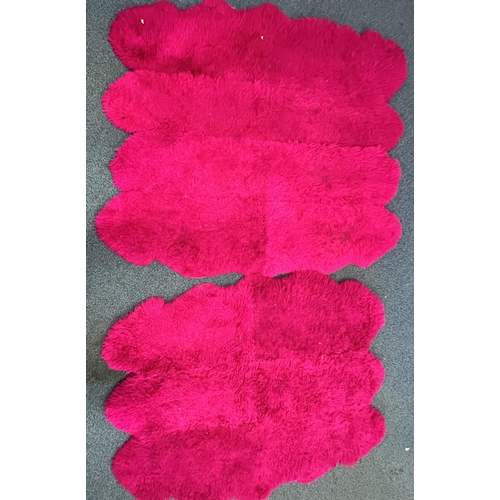 1370 - TWO PINK FAUX FUR RUGS, largest rug, 183cm x 207cm, and a modern purple rug (3)