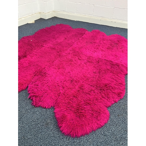 1370 - TWO PINK FAUX FUR RUGS, largest rug, 183cm x 207cm, and a modern purple rug (3)