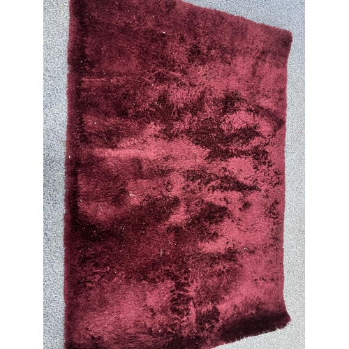 1370 - TWO PINK FAUX FUR RUGS, largest rug, 183cm x 207cm, and a modern purple rug (3)