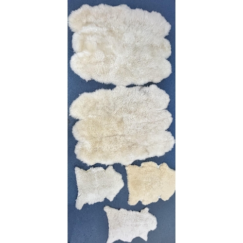 1371 - TWO LARGE FAUX SHEEP SKIN RUGS, 185cm x 151cm, and three small sheep skin rugs (5)