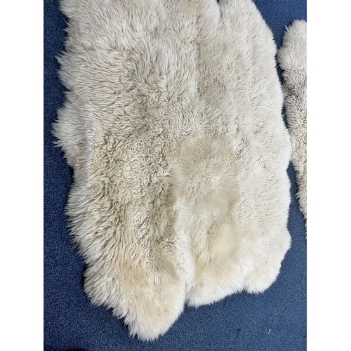 1371 - TWO LARGE FAUX SHEEP SKIN RUGS, 185cm x 151cm, and three small sheep skin rugs (5)