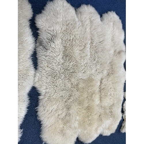 1371 - TWO LARGE FAUX SHEEP SKIN RUGS, 185cm x 151cm, and three small sheep skin rugs (5)