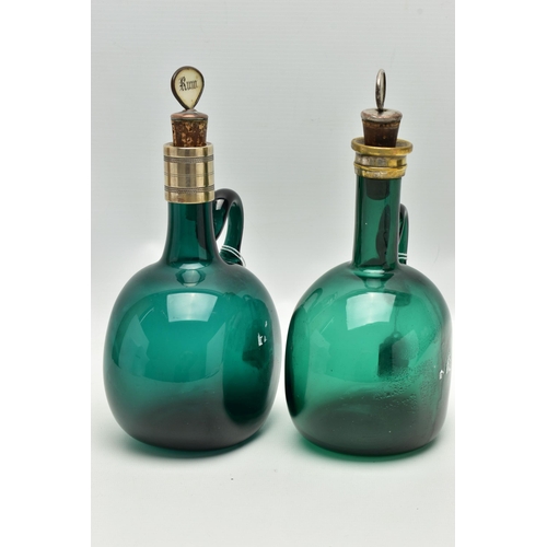 808A - TWO VICTORIAN GREEN GLASS DECANTERS WITH METAL MOUNTS AND LOOP HANDLES, both with an ill-fitting mot... 