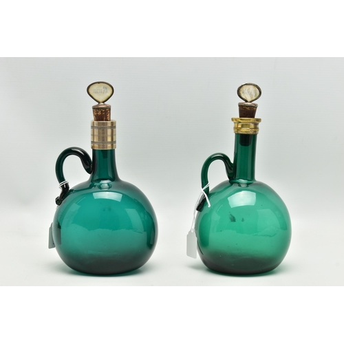 808A - TWO VICTORIAN GREEN GLASS DECANTERS WITH METAL MOUNTS AND LOOP HANDLES, both with an ill-fitting mot... 