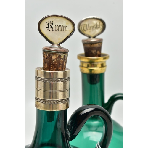 808A - TWO VICTORIAN GREEN GLASS DECANTERS WITH METAL MOUNTS AND LOOP HANDLES, both with an ill-fitting mot... 