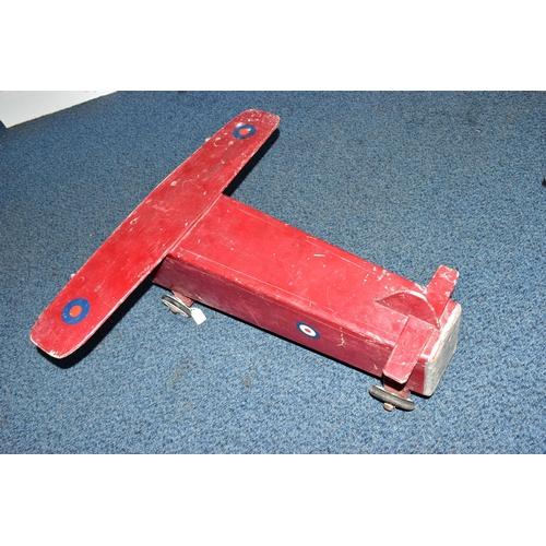 852A - A CHILD'S SIT-ON PUSH ALONG TOY IN THE FORM OF A WOODEN PLANE, with RAF logos, on plastic and rubber... 