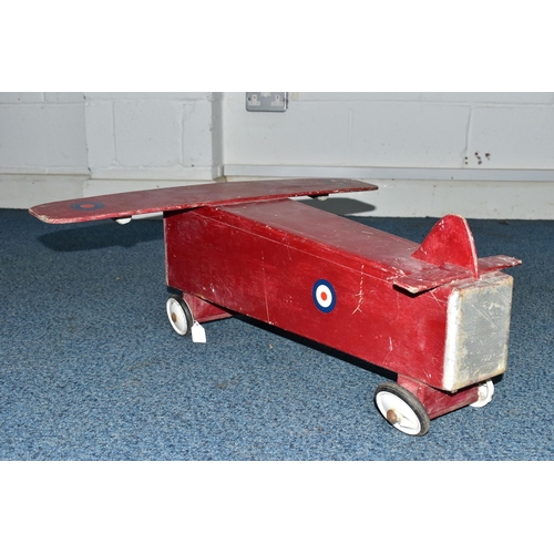 852A - A CHILD'S SIT-ON PUSH ALONG TOY IN THE FORM OF A WOODEN PLANE, with RAF logos, on plastic and rubber... 