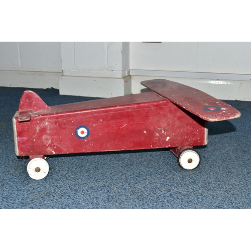 852A - A CHILD'S SIT-ON PUSH ALONG TOY IN THE FORM OF A WOODEN PLANE, with RAF logos, on plastic and rubber... 