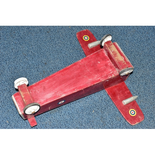 852A - A CHILD'S SIT-ON PUSH ALONG TOY IN THE FORM OF A WOODEN PLANE, with RAF logos, on plastic and rubber... 