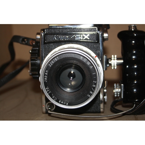 859 - A KOWA SIX MEDIUM FORMAT FILM CAMERA  fitted with a Kowa 85mm f2 lens, a Hand Grip and a Kowa 150mm ... 