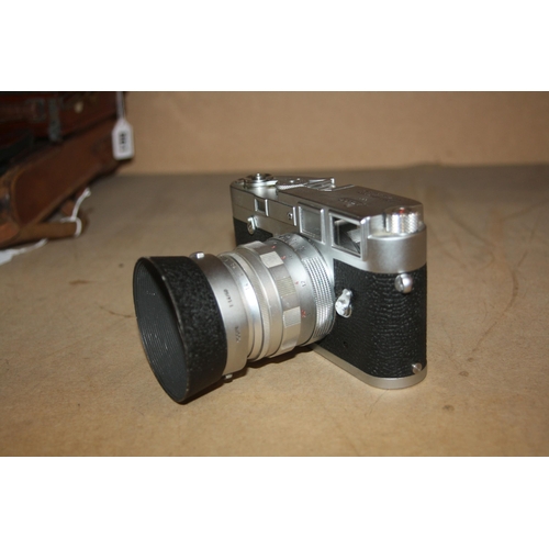 863 - A LEICA M3 CHROME RANGEFINDER CAMERA Serial no 1002606 fitted with a Summilux 50mm f1.4 lens and len... 