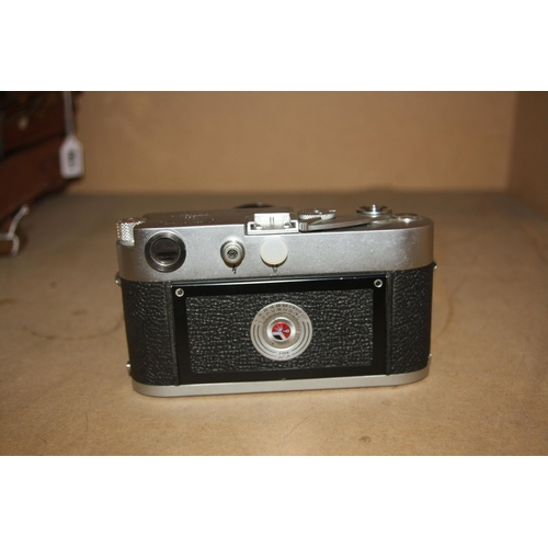 863 - A LEICA M3 CHROME RANGEFINDER CAMERA Serial no 1002606 fitted with a Summilux 50mm f1.4 lens and len... 