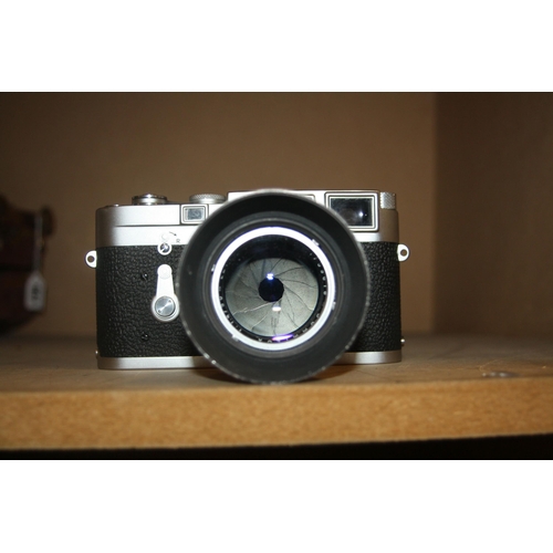 863 - A LEICA M3 CHROME RANGEFINDER CAMERA Serial no 1002606 fitted with a Summilux 50mm f1.4 lens and len... 