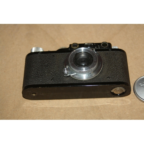 868 - A 1932 LEICA ll FILM CAMERA in black Serial No 93848 fitted with an Elmar 50mm f3.5 lens with lens c... 