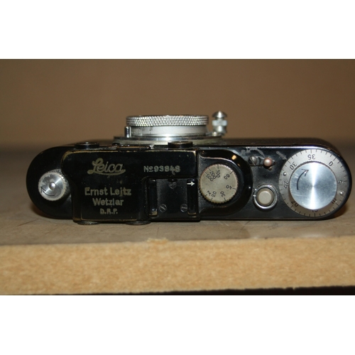 868 - A 1932 LEICA ll FILM CAMERA in black Serial No 93848 fitted with an Elmar 50mm f3.5 lens with lens c... 