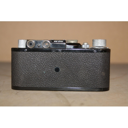 868 - A 1932 LEICA ll FILM CAMERA in black Serial No 93848 fitted with an Elmar 50mm f3.5 lens with lens c... 