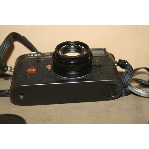 883 - A LEICA M4P FILM CAMERA in black Serial No 1547392 fitted with an Elmar M 50mm f2.8 lens, an Elmar 9... 