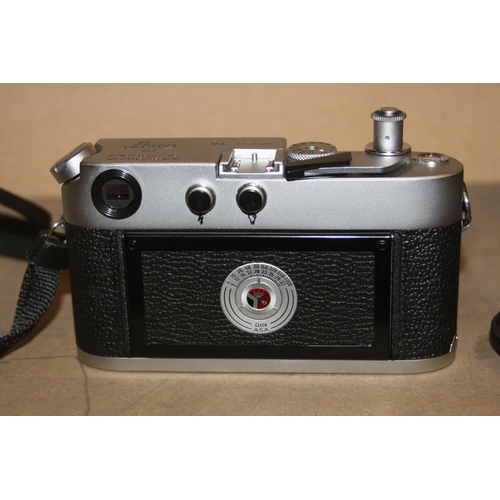 885 - A LEICA M4 FILM CAMERA in chrome Serial No 1176521 fitted with an Elmar 50mm f2.8 lens, two lens cap... 