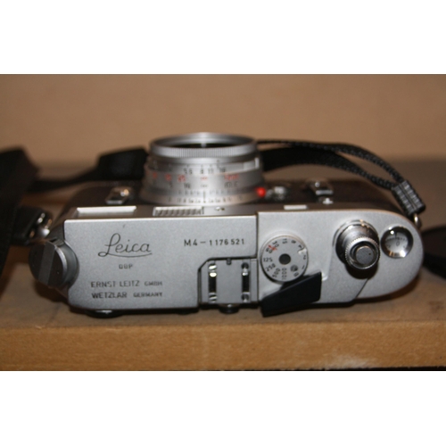 885 - A LEICA M4 FILM CAMERA in chrome Serial No 1176521 fitted with an Elmar 50mm f2.8 lens, two lens cap... 