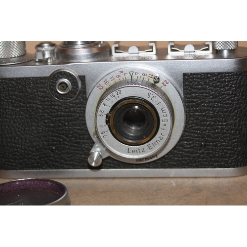 889 - A LEICA 1F FILM CAMERA Serial No 807537 fitted with an Elmar 5cm f3.5 lens with cap and viewer