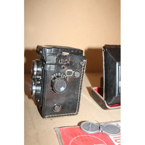 898 - A YASHICA MAT 124G TLR CAMERA with 80mm f 2.8 and f3.5 lenses and leather case along with Yahica Gui... 