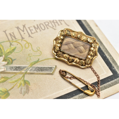 910A - TWO EARLY 20TH CENTURY MEMORIAL BROOCHES, the first a gold brooch, rectangular form, a central glass... 