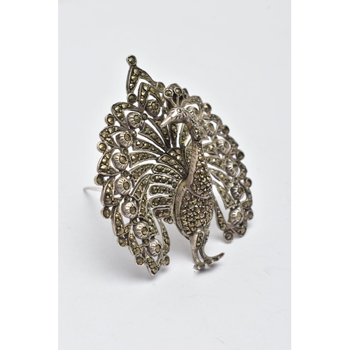 928A - A WHITE METAL AND MARCASITE BROOCH, in the form of a peacock, open work detail set with circular cut... 