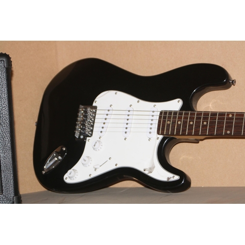 930 - A CB SKY STRAT TYPE GUITAR with black finish and a Ion iGA03 practice amp (untested)