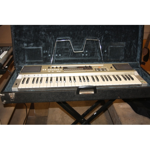 936 - A CASIOTONE 7000 ELECTRONIC KEYBOARD and a Roland EM15 electronic keyboard and two stands ( no power... 