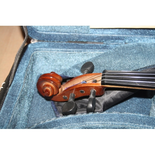 939 - TWO MODERN VIOLINS IN CASES one is a Chinese MV007 the other is unbranded with two bows