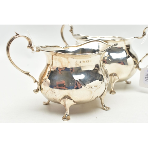 154 - AN EDWARDIAN SILVER TWIN HANDLED SUGAR BOWL AND MILK JUG OF BOMBÉ FORM, on four cabriole legs, maker... 