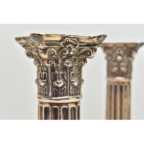 156 - A PAIR OF GEORGE V SILVER CORINTHIAN COLUMN CANDLESTICKS, fluted and stop reeded columns on stepped ... 