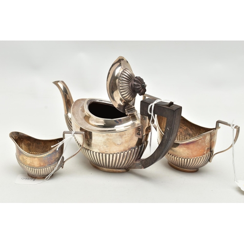 164 - AN EDWARDIAN SILVER THREE PIECE BACHELOR'S TEA SET OF OVAL FORM, reeded decoration to the lower half... 