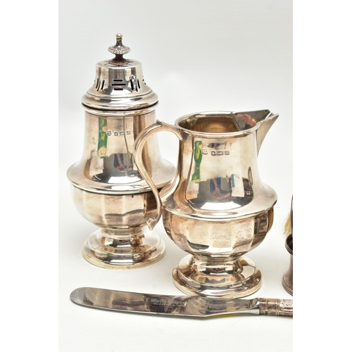 166 - A SMALL PARCEL OF 20TH CENTURY SILVER, comprising a George V sugar caster and matching cream jug of ... 