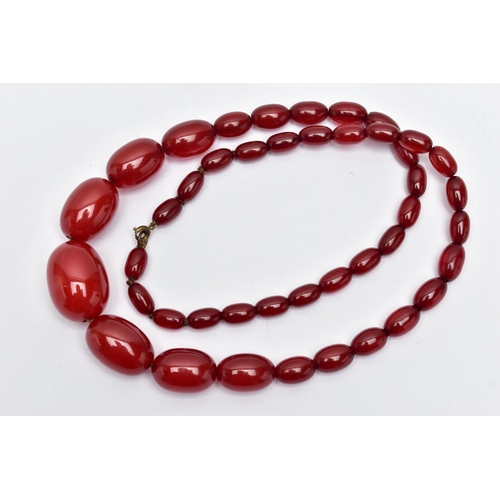 25 - A GRADUATED BAKELITE BEAD NECKLACE, comprising of forty-three oval beads, largest measuring approxim... 