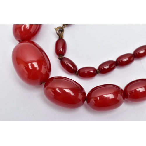 25 - A GRADUATED BAKELITE BEAD NECKLACE, comprising of forty-three oval beads, largest measuring approxim... 