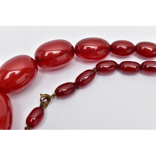 25 - A GRADUATED BAKELITE BEAD NECKLACE, comprising of forty-three oval beads, largest measuring approxim... 