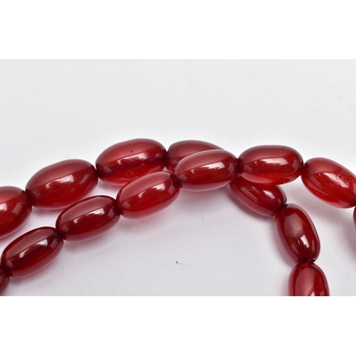 25 - A GRADUATED BAKELITE BEAD NECKLACE, comprising of forty-three oval beads, largest measuring approxim... 