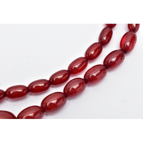 25 - A GRADUATED BAKELITE BEAD NECKLACE, comprising of forty-three oval beads, largest measuring approxim... 